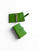 Two green leather wallets are shown on a white background.