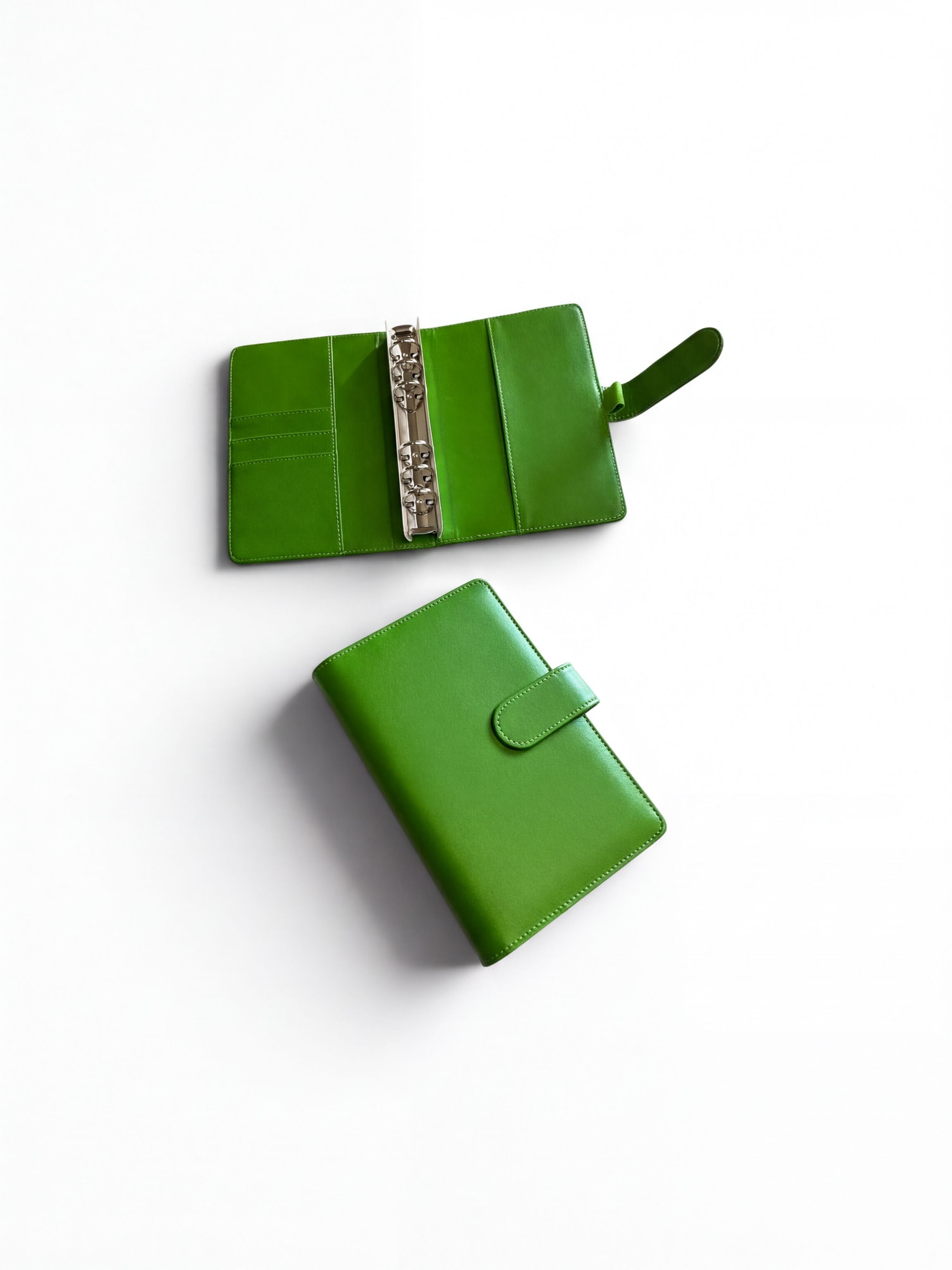 Two green leather wallets are shown on a white background.
