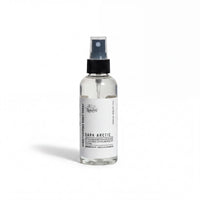 A clear glass bottle with a black spray nozzle, containing a clear liquid, labeled as "Dark Arctic" with a black cap.