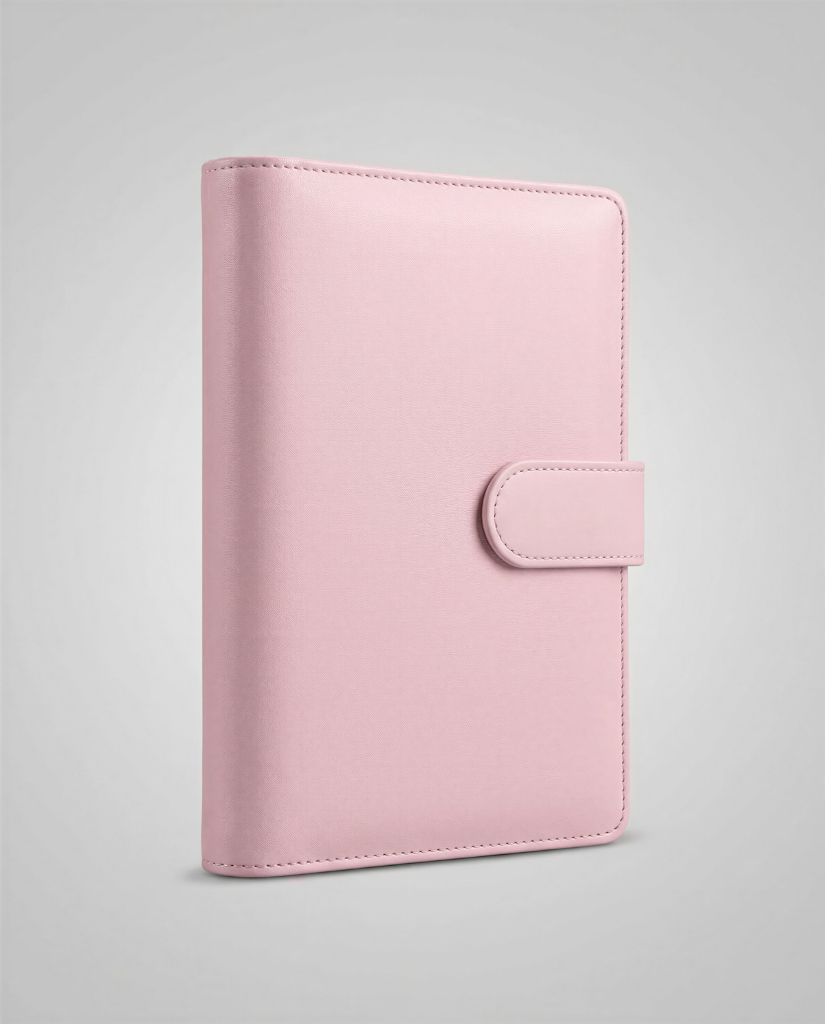 A pink leather-bound notebook or planner with a simple, minimalist design.