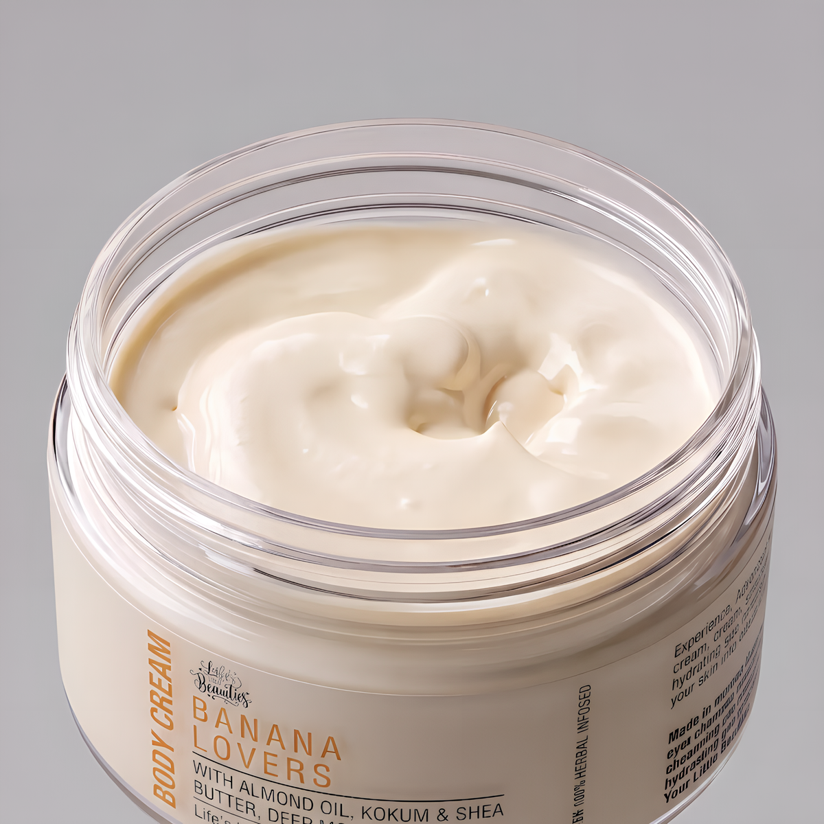 A jar of body cream with a creamy, white texture and a label that reads "Body Cream BANANA LOVERS with Almond Oil, Butter, Cocoa & Shea Butter, Coconut Oil, Kukum & Shea Butter, Life-Changing".