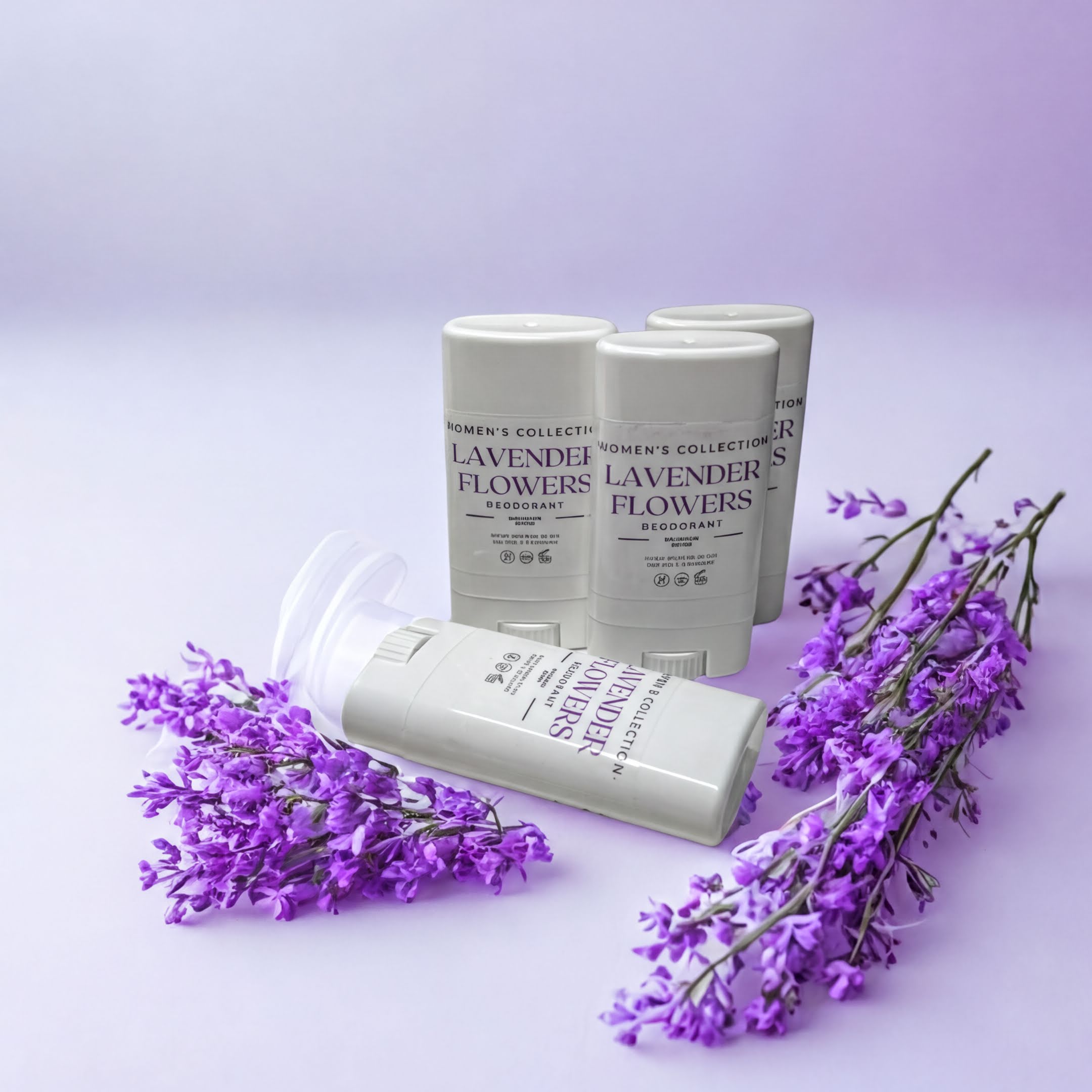 three white cylindrical containers with purple text, surrounded by purple flowers on a purple background.