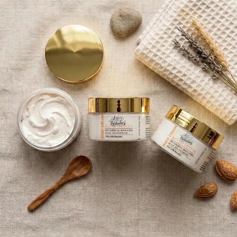 a collection of beauty products, including jars of cream, a wooden spoon, and some nuts, arranged on a beige background.