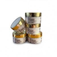 a stack of four jars with gold-colored lids, each containing a different product labeled as "Mangly Teakwood".