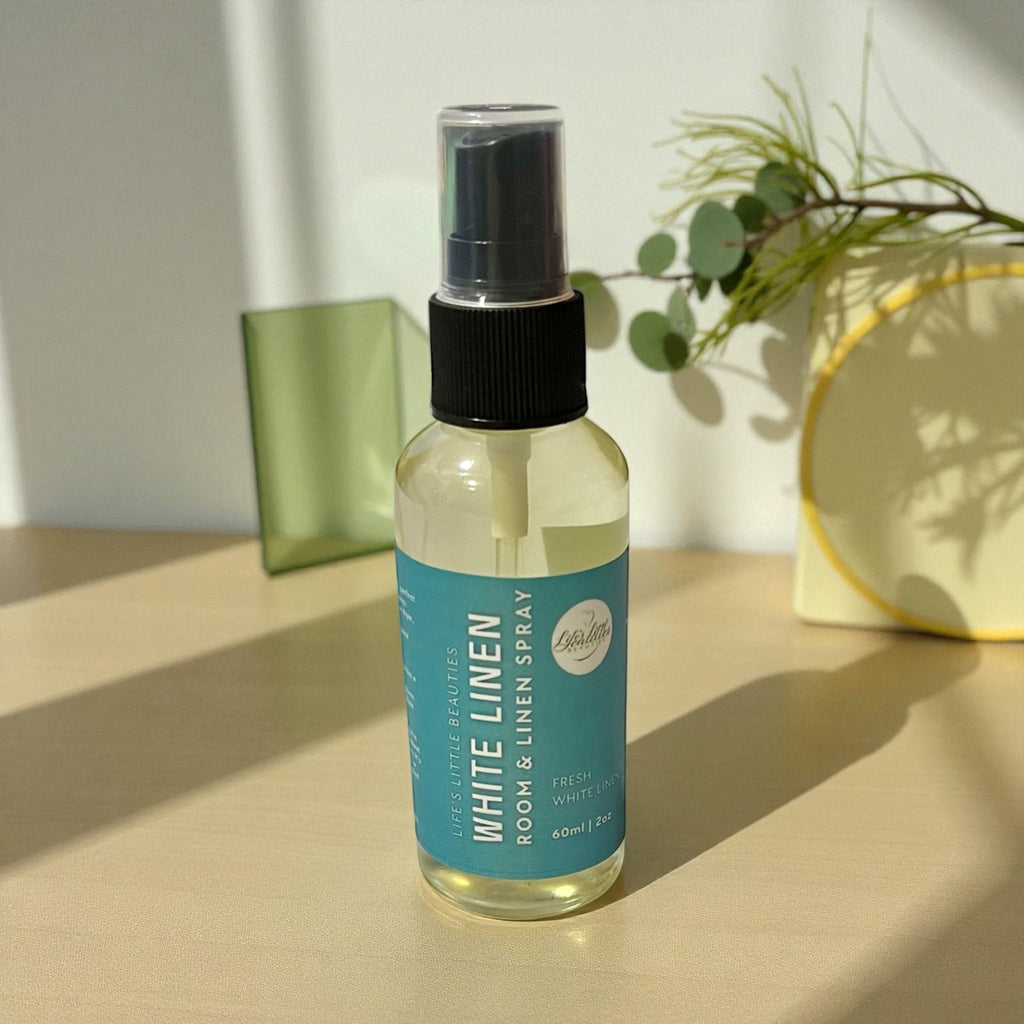 White Linen room & linen spray with natural ingredients, fresh scent in clear bottle on sunny surface