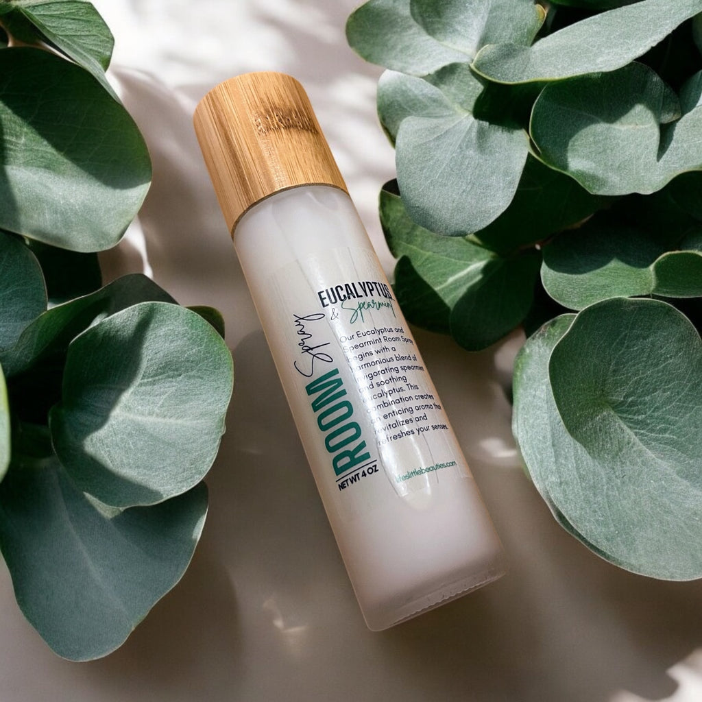 Eucalyptus & Spearmint room spray with bamboo cap, surrounded by fresh eucalyptus leaves, natural aromatherapy