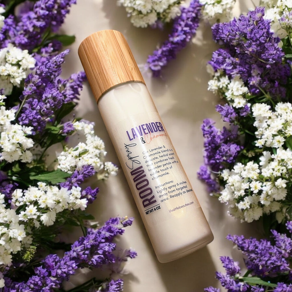 Lavender & chamomile room spray with natural ingredients, surrounded by fresh purple and white flowers