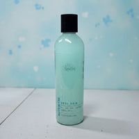 A bottle of "Cool Rain" body wash against a blue background.