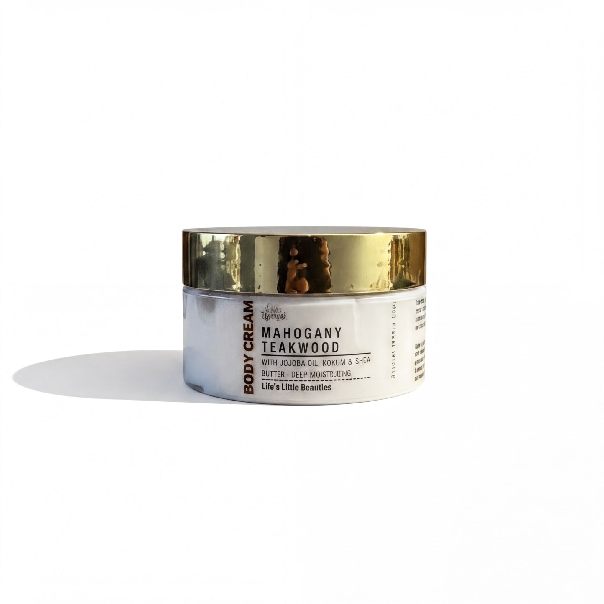A jar of body cream with a gold lid, labeled as "Mahogany Teakwood".