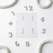 a collection of numbers and numbers on a white background, arranged in a circular pattern.