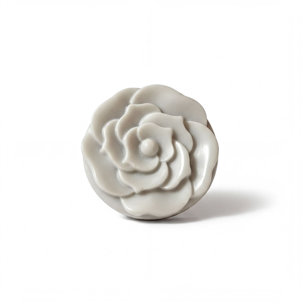 A white, round, flower-shaped object is shown against a white background.