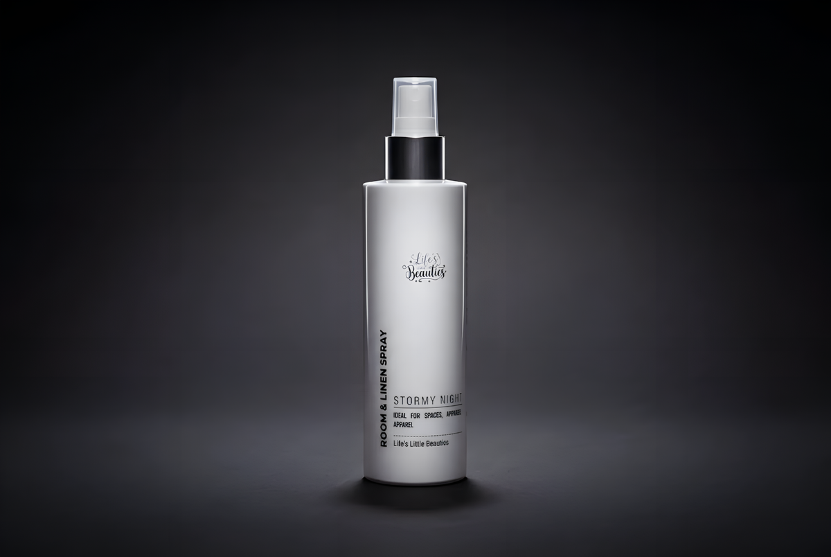 A bottle of "Lets Go With Linen Spray" against a dark background.