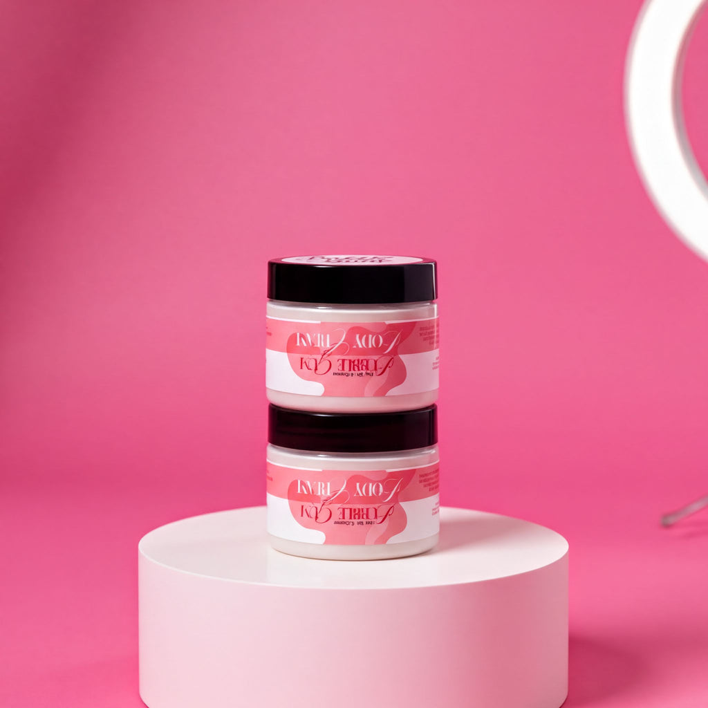 Two jars of pink hair color products are stacked on a white pedestal against a pink background.
