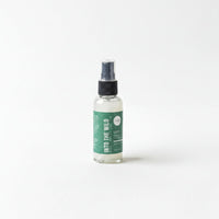 A bottle of "Into the Wild" lotion is shown against a white background.