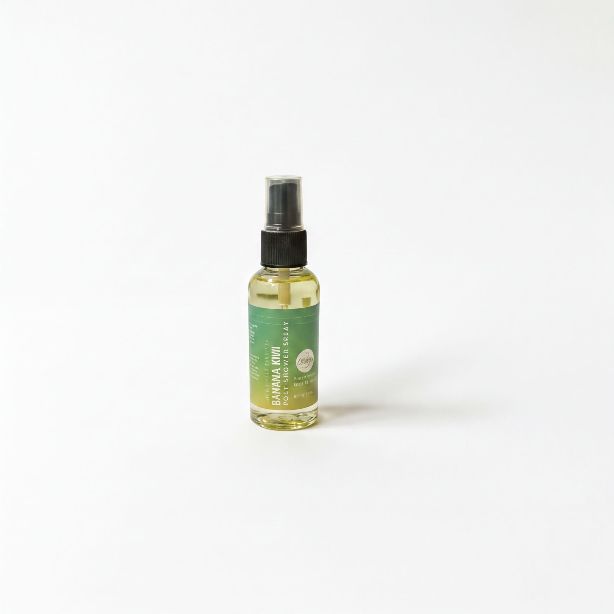 A bottle of liquid with a green label is standing upright on a white background.