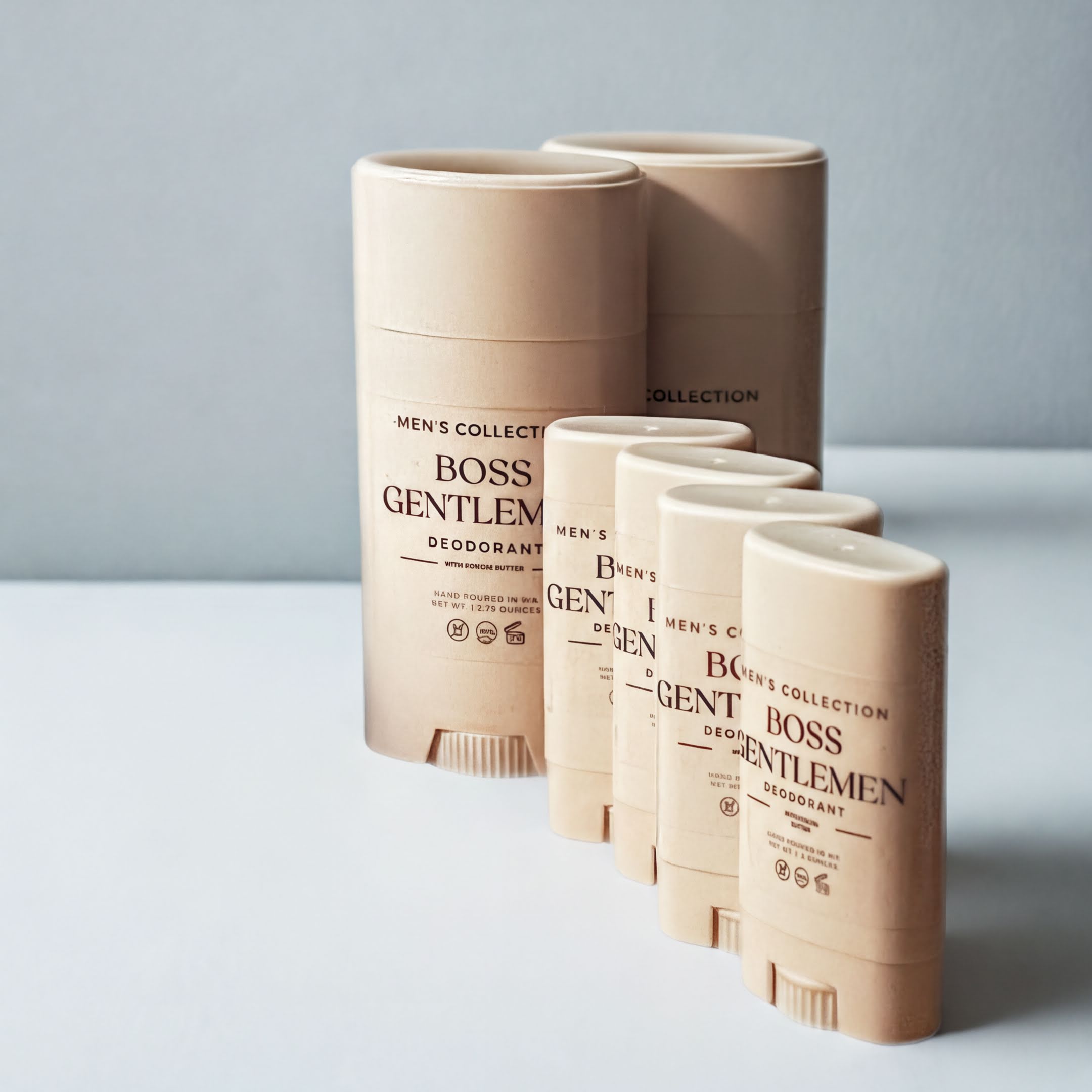 A row of beige deodorant sticks with the text "MEN'S COLLECTION" printed on them, along with the text "BOSS GENTLEM" and "BOSS" printed on the side of the sticks.