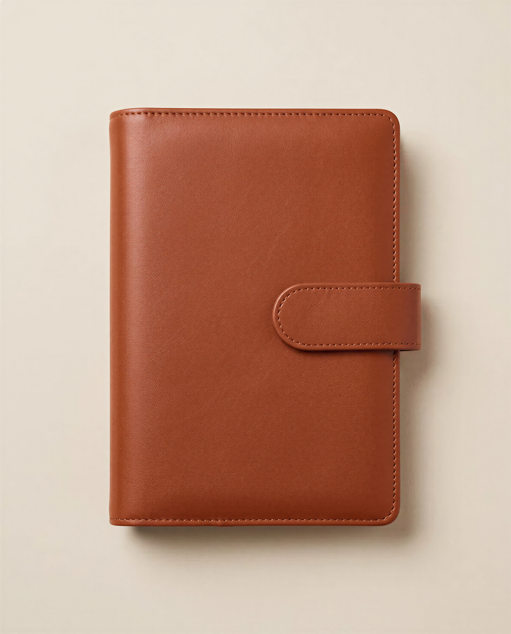 A brown leather-bound notebook or planner with a simple, classic design.