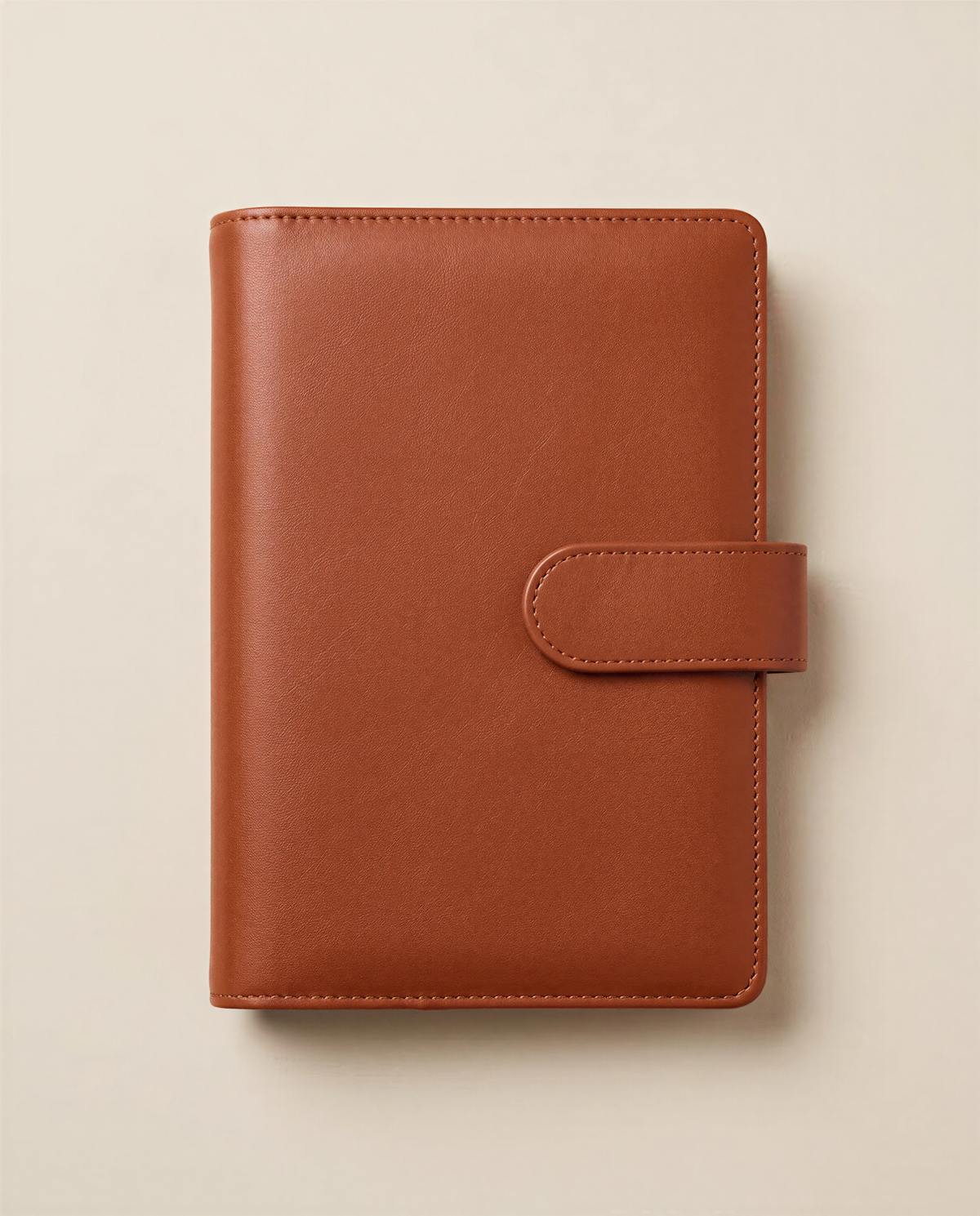 A brown leather-bound notebook or planner with a simple, classic design.