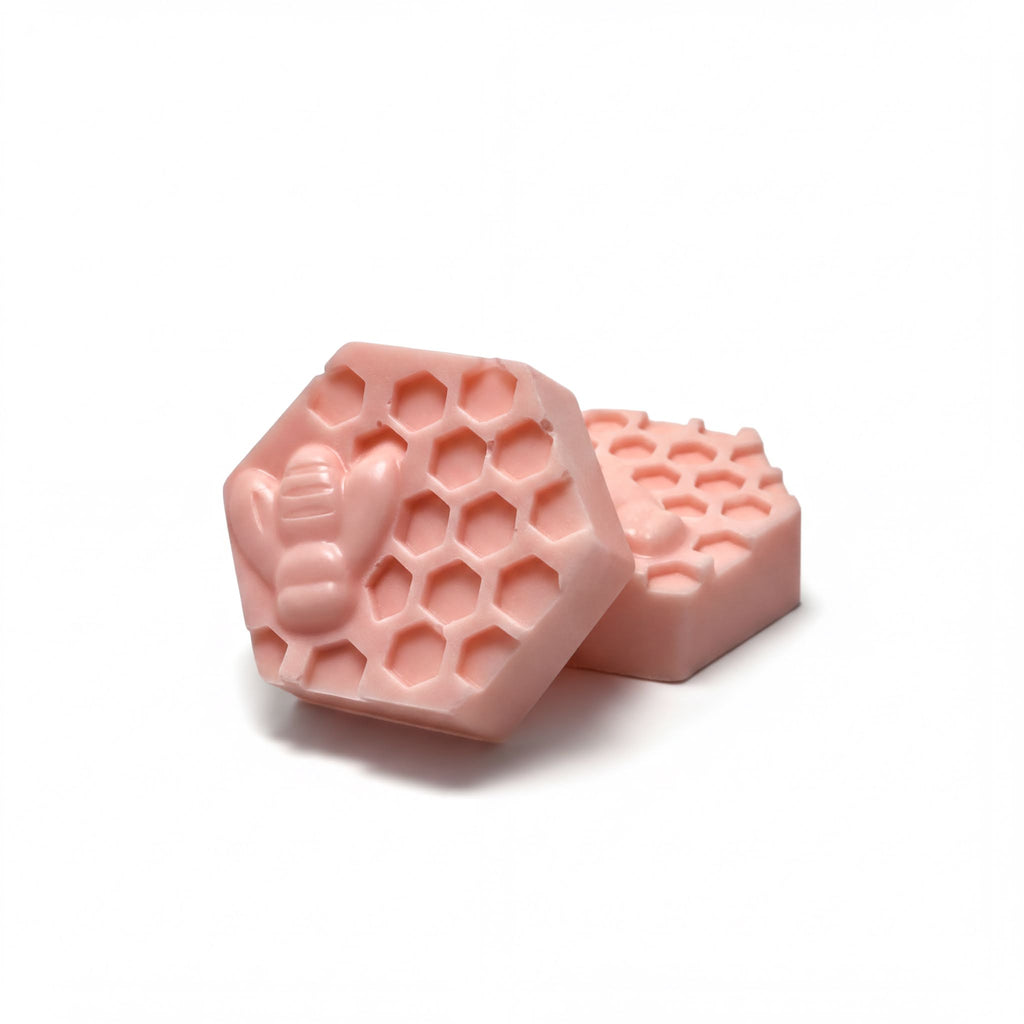 Pink hexagonal goat milk soap bars with honeycomb and bee design, natural handmade skincare