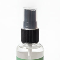 A spray bottle with a black pump and a black cap.