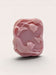 A pink soap bar with a cat and butterflies carved into it.