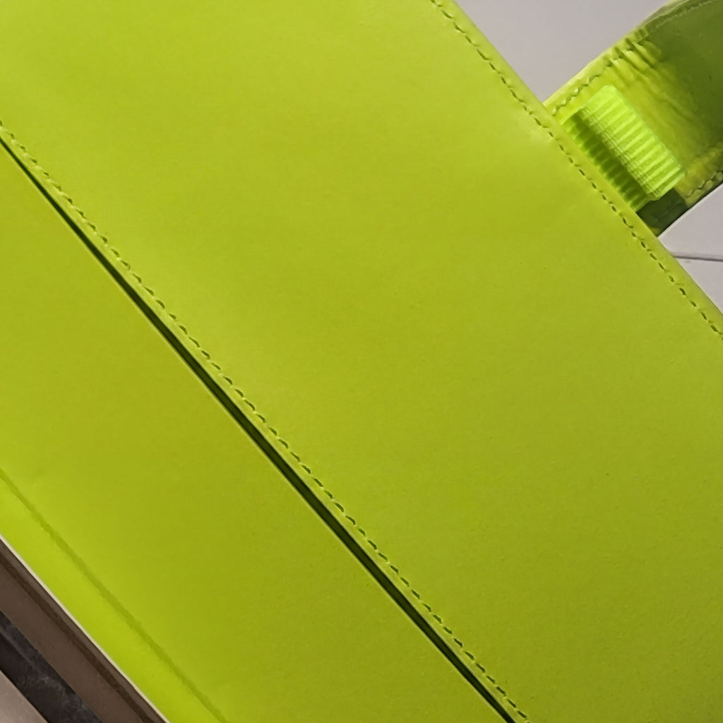 Vibrant lime green handcrafted soap bar with textured edge and natural ingredients