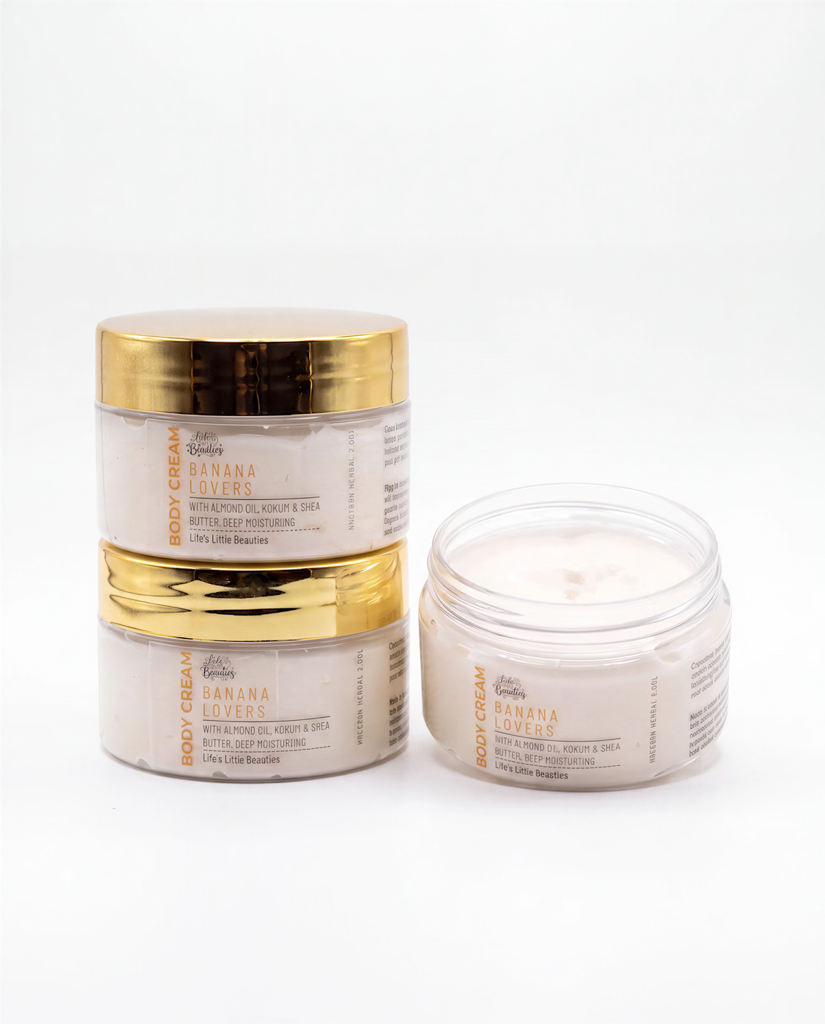three jars of body cream with a focus on the one in the front.
