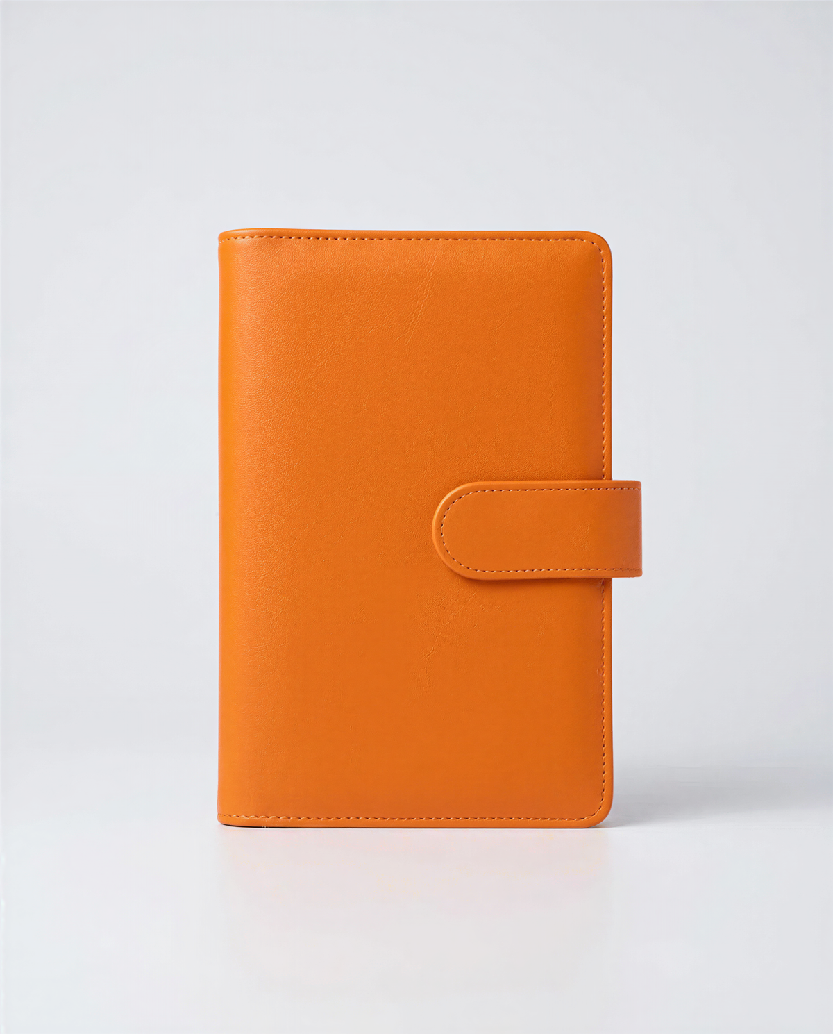 A single, bright orange leather wallet or card holder is shown against a plain white background.