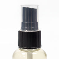 A spray bottle with a black pump and a black cap.