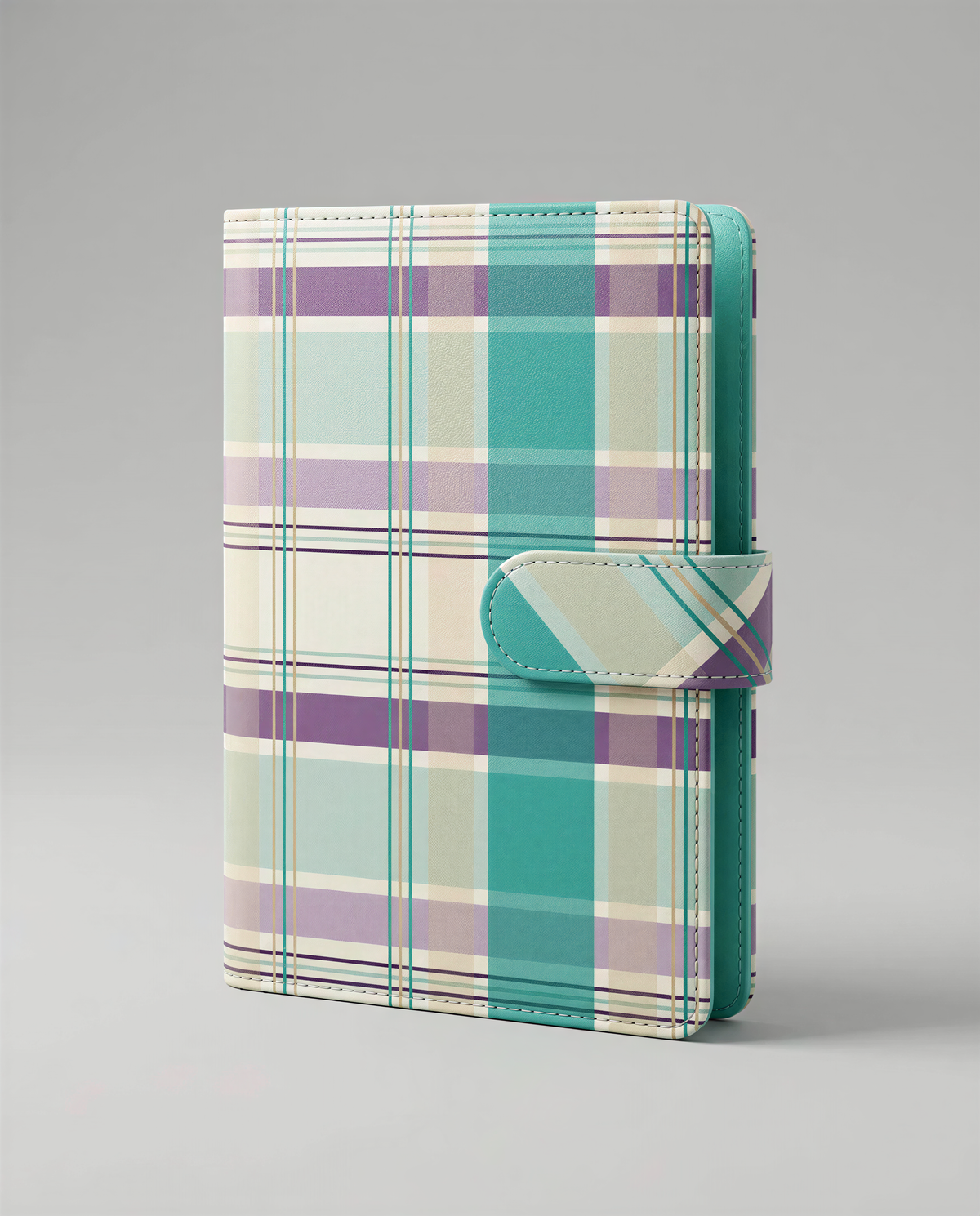 A colorful plaid wallet or card holder with a teal-colored flap closure.