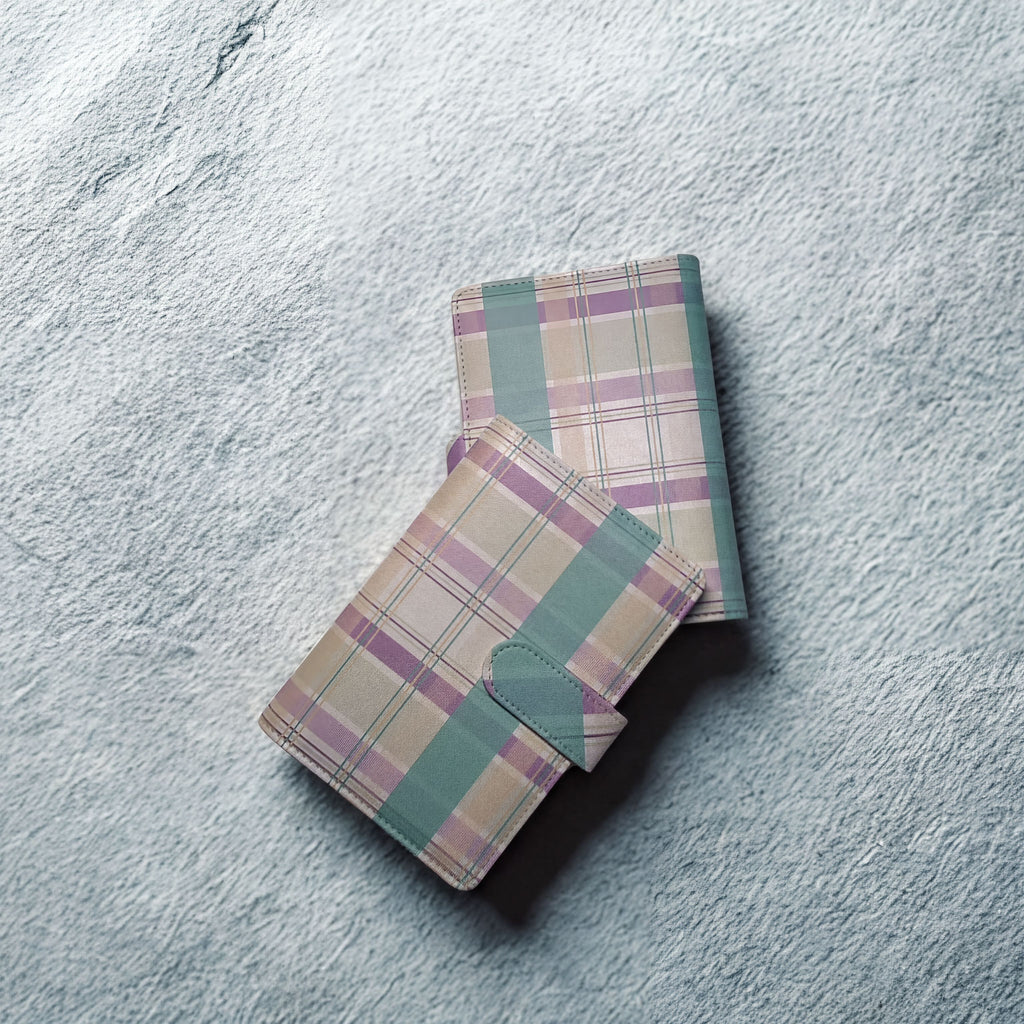 Plaid patterned wallet with mint green accents on textured surface