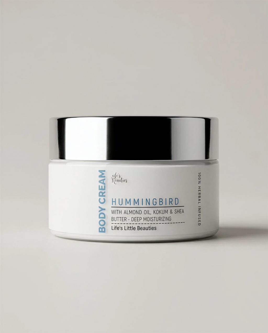 A jar of Hummingbird Body Cream with Almond Oil, Cocoa Butter, and Deep Moisturizing ingredients.
