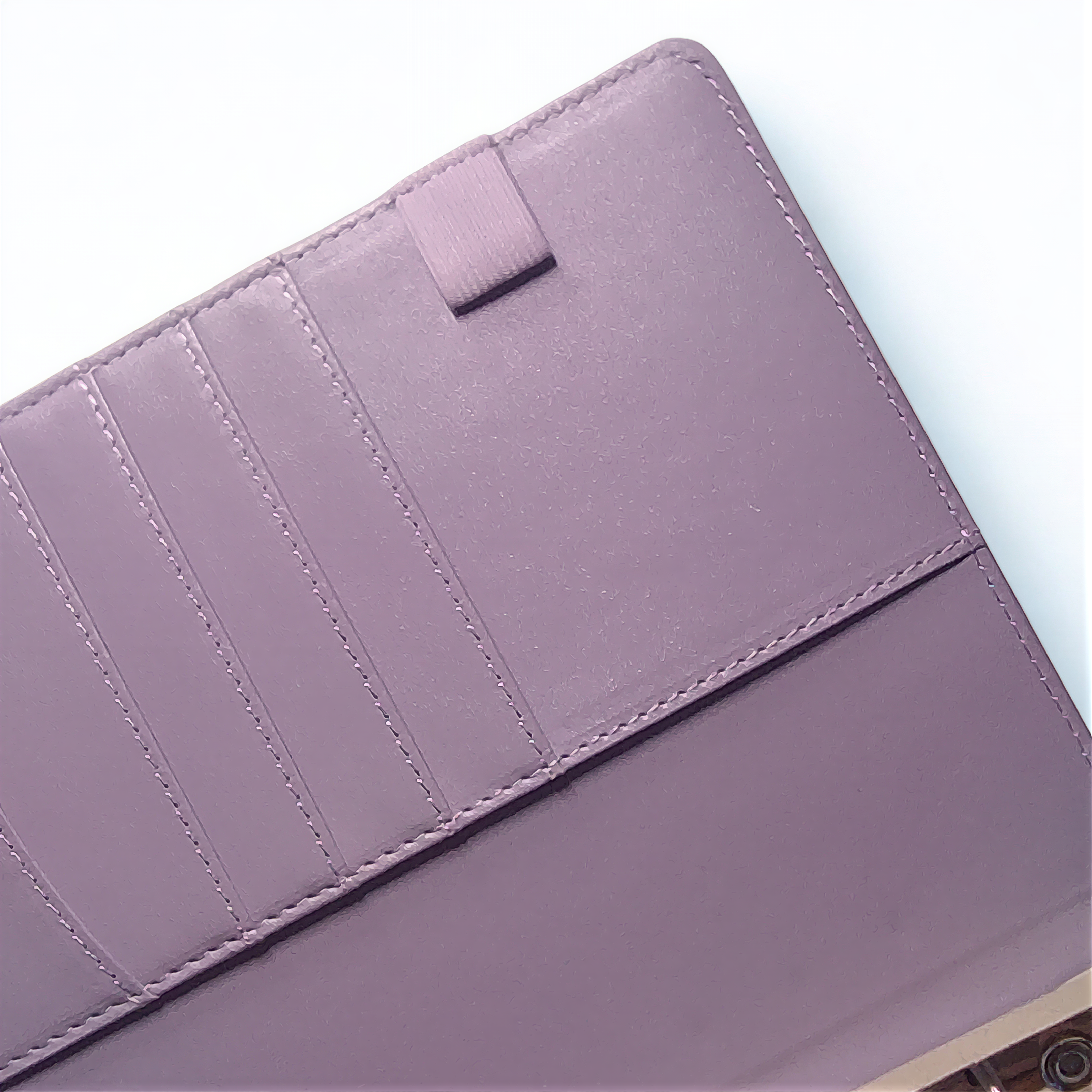 A close-up view of a purple leather wallet or card holder with multiple card slots visible.