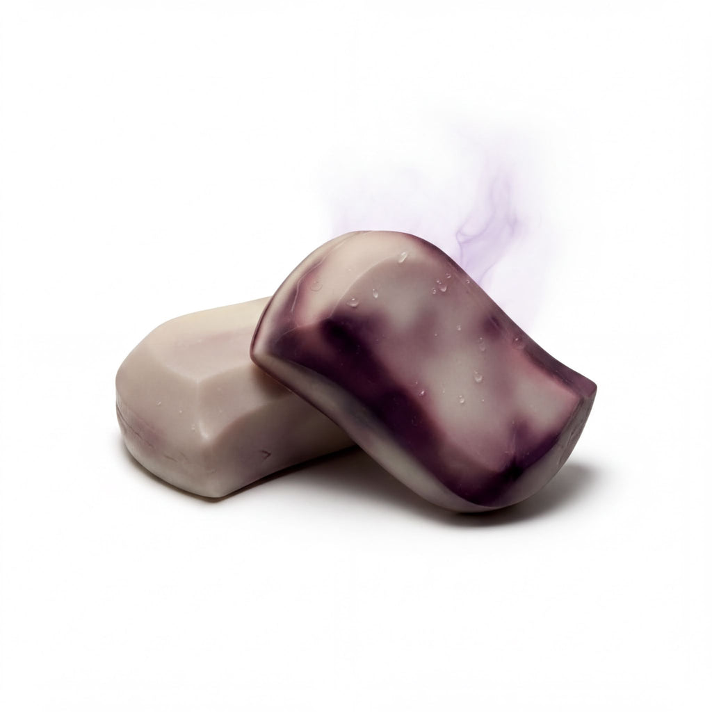 Handcrafted goat milk soap bars with natural purple swirls, dewy texture, and gentle steam for a soothing bath experience.