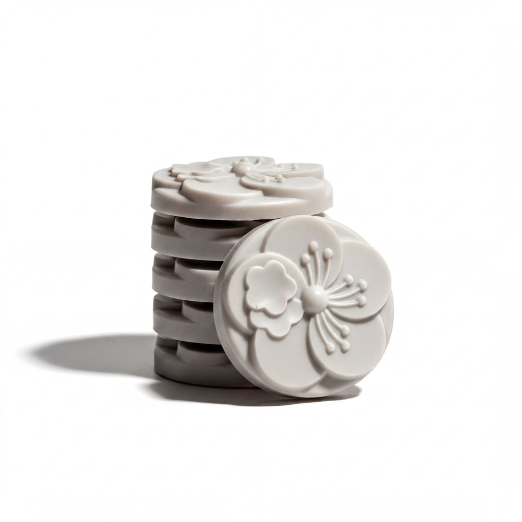 A stack of gray, circular objects with intricate floral designs on them.