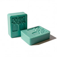 Two green rectangular bars with tree designs on them, placed side by side against a white background.