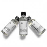 Three bottles of dark Arctic body oil are arranged in a row against a white background.