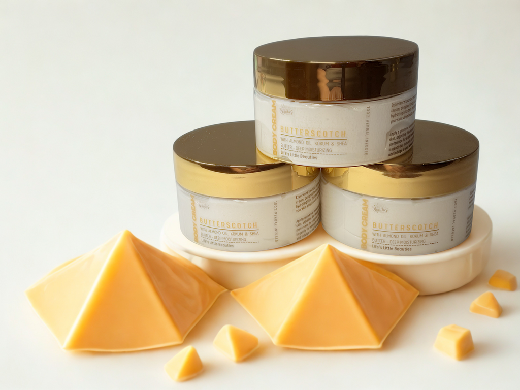 three jars of Butterscotch with golden lids, arranged in a pyramid formation, and there are some golden cubes scattered around the jars.