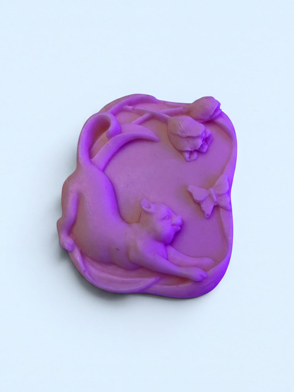 A purple, three-dimensional cat figurine is depicted against a light blue background.