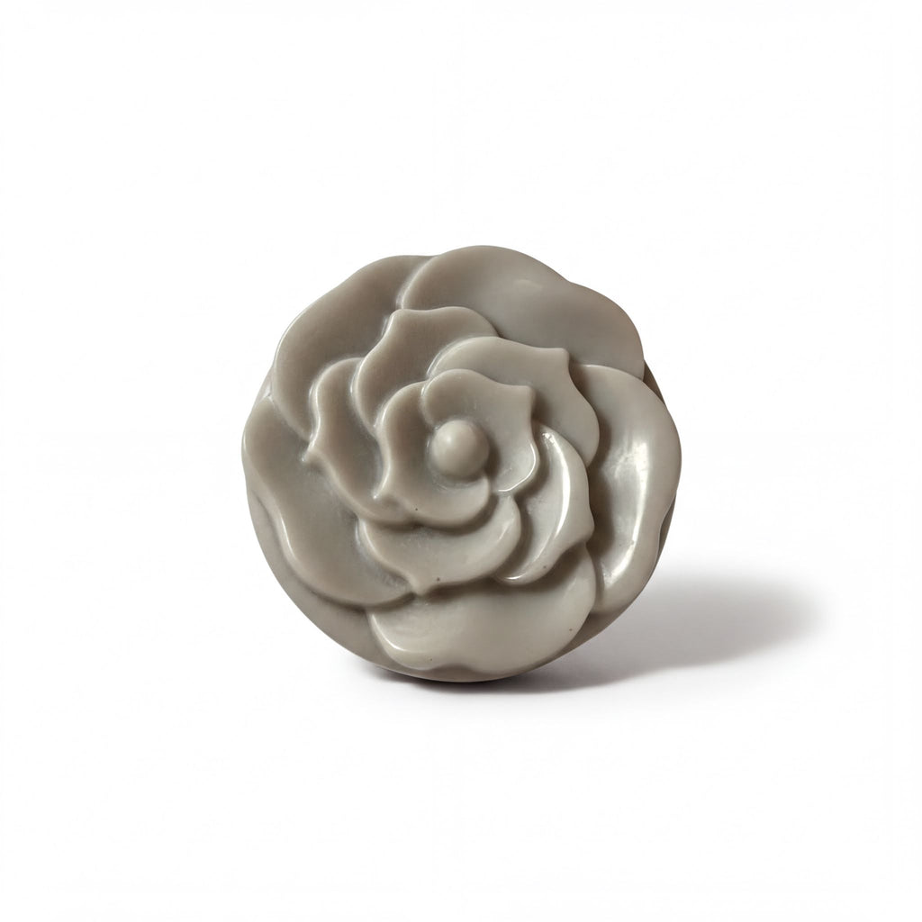 A gray, round, flower-shaped object is shown against a white background.