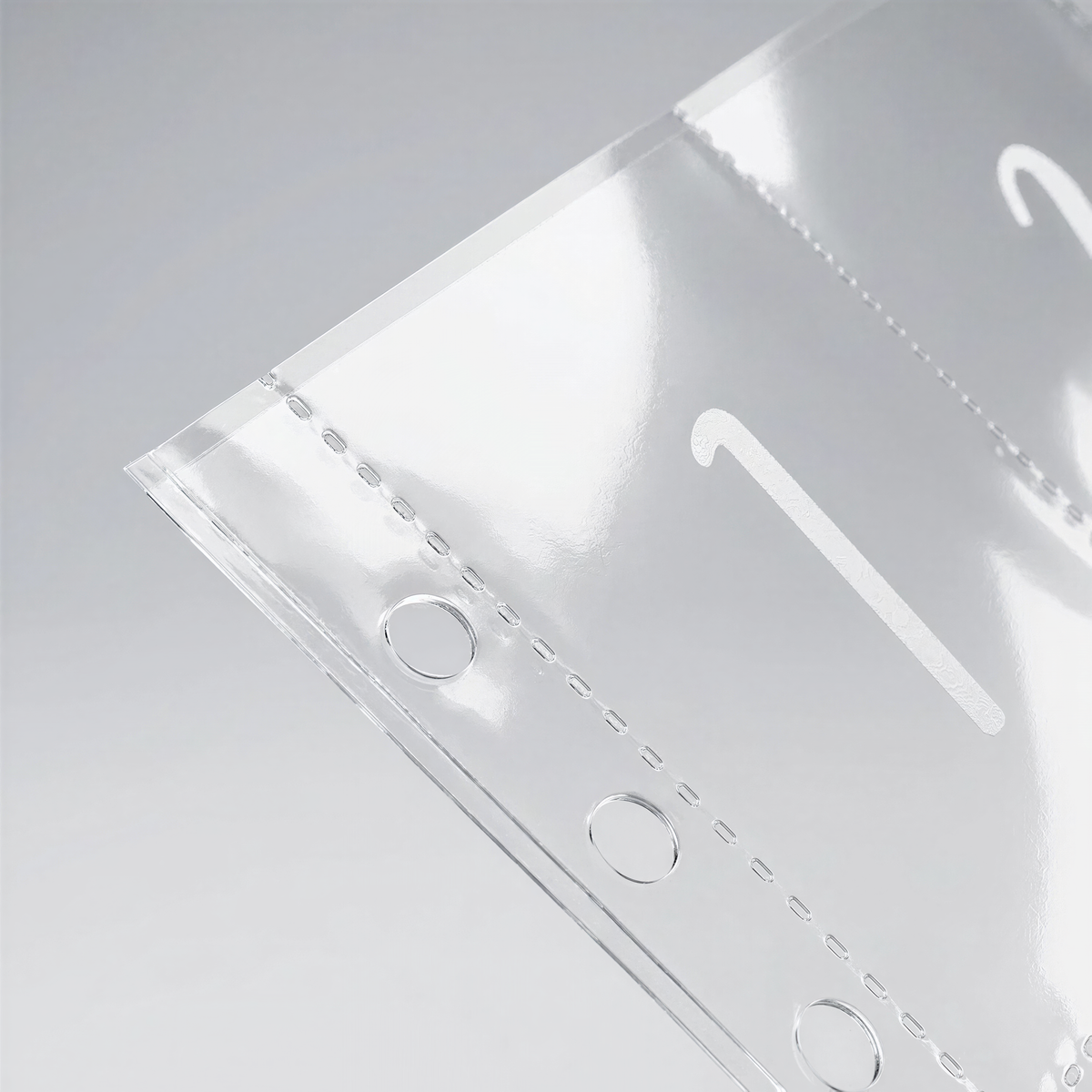a close-up view of a clear plastic object with a number printed on it, which appears to be a page from a book or a similar type of material.