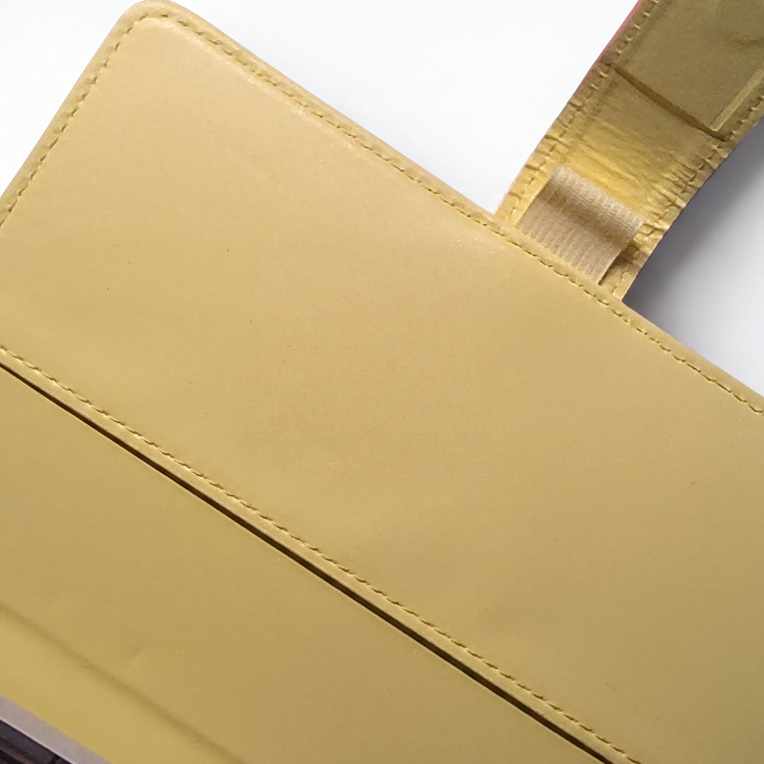 Yellow leather wallet with detailed stitching and card slots