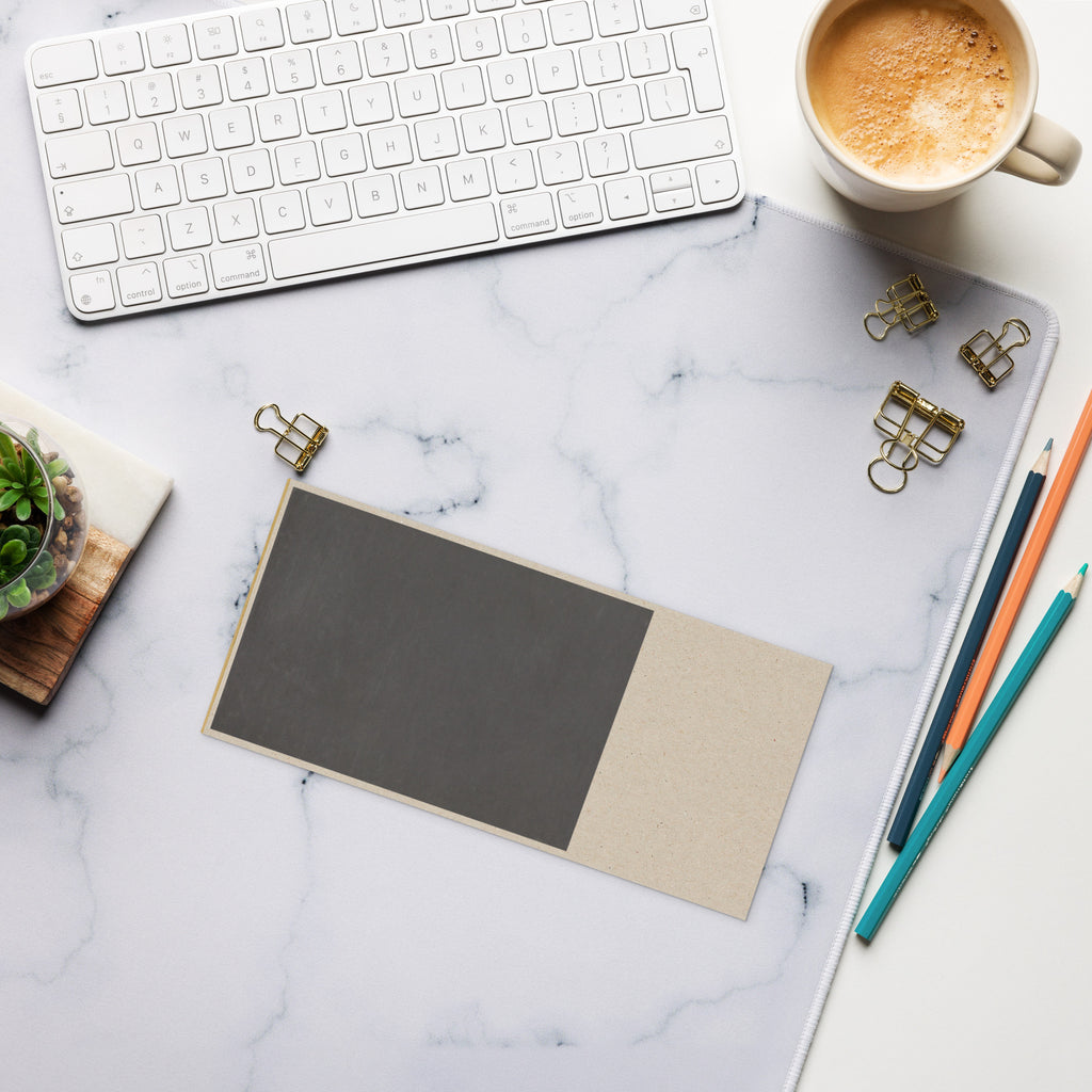 Marble desk with keyboard, coffee, gold clips, pencils, and notebook — natural, minimalist workspace setup